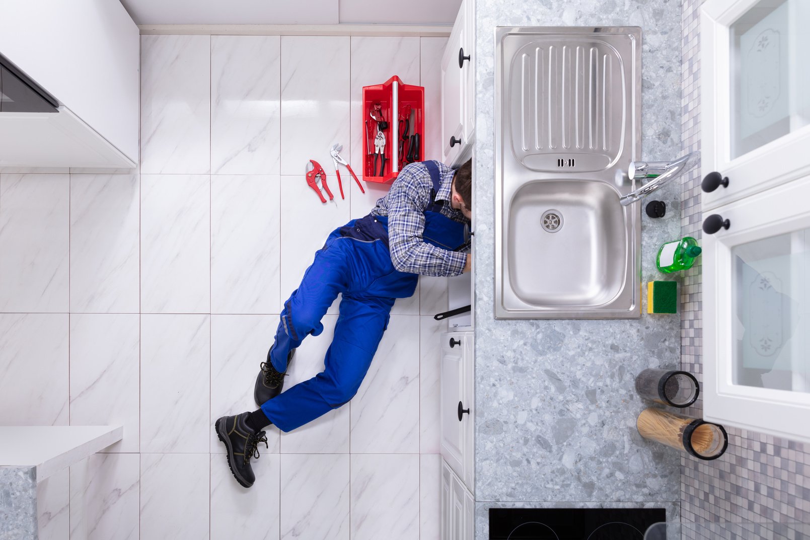 Plumber Repairing Sink Pipe